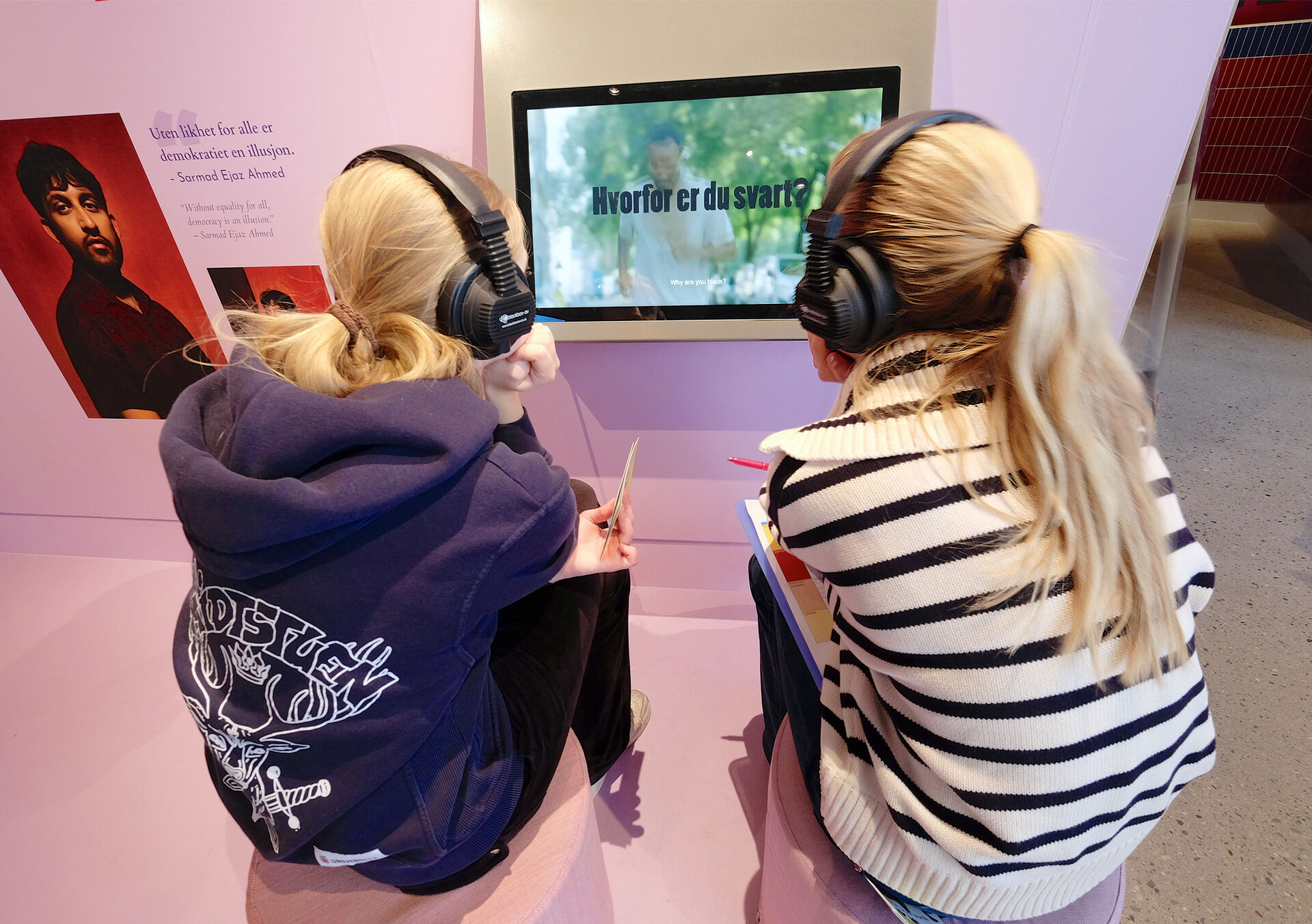 Two young girls with headset watching a screem
